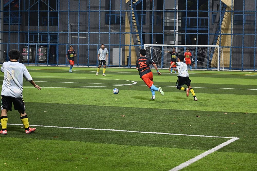 DFC 5331 A late-night match at Klet Kaeo a player in red sprints towar